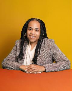 JeMiah Israel headshot, with orange-yellow background