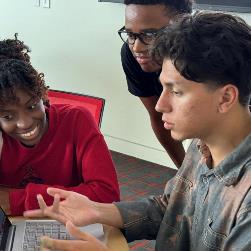 interns work with student mentor on CSS assignment